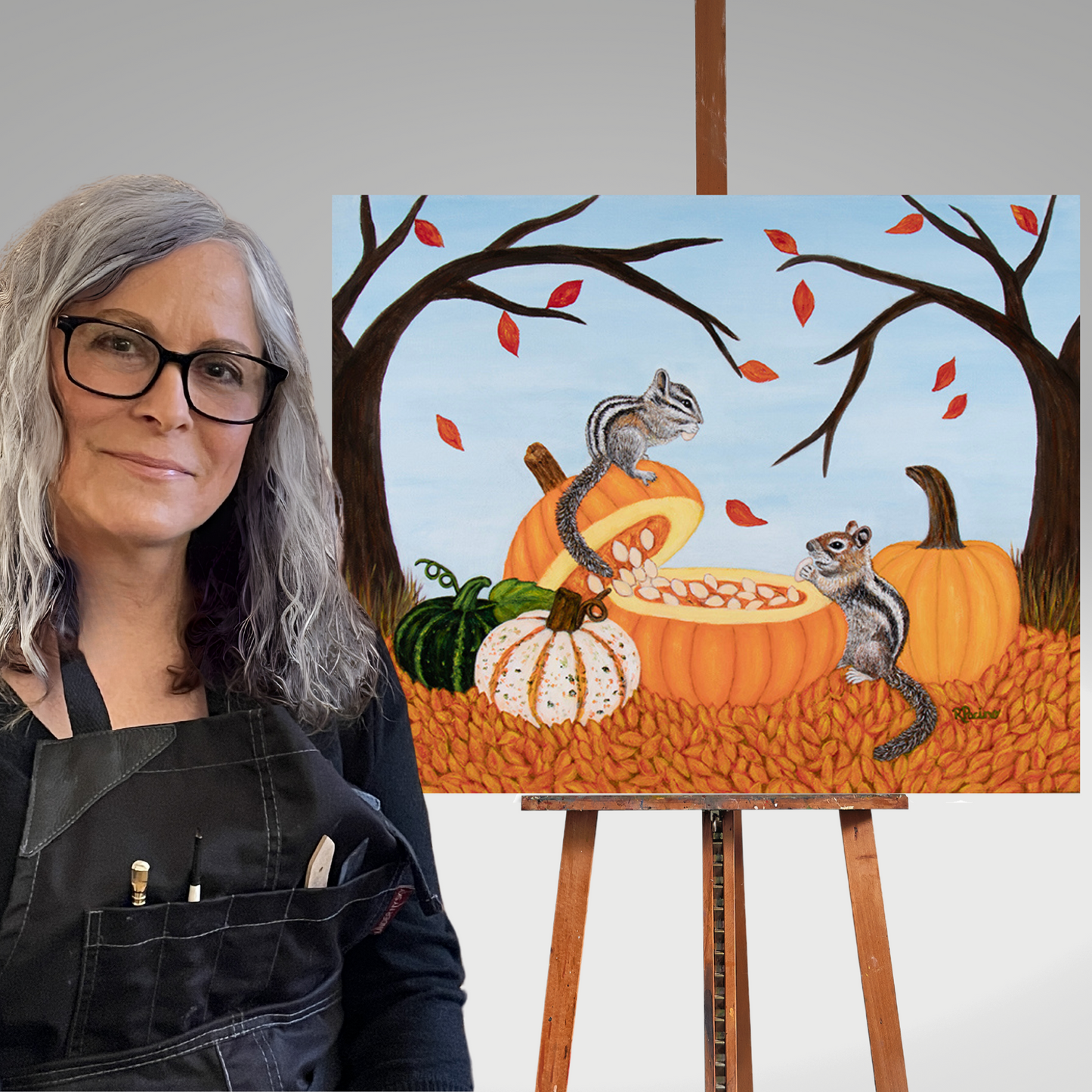Artist Roberta Pacino displaying her Pumkin Patch Painting on an easel.