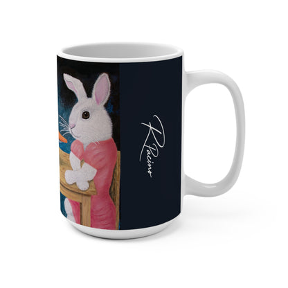 A white ceramic mug featuring a printed design of a white rabbit in a pink dress sitting at a table against a dark background, with a white script signature on the right side of the print.