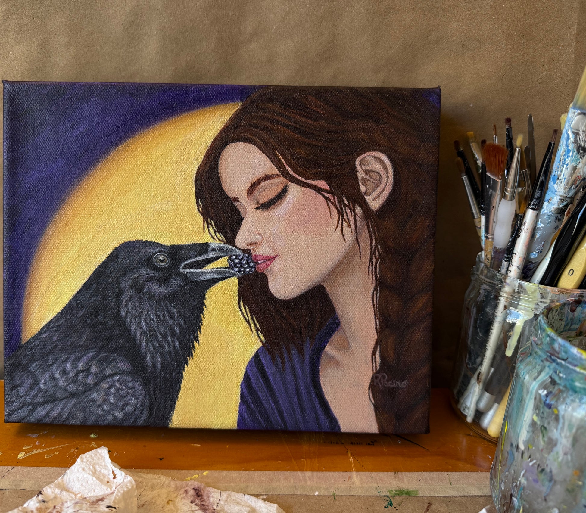 Raven's Offering original painting in artist studio with brushes and canvas