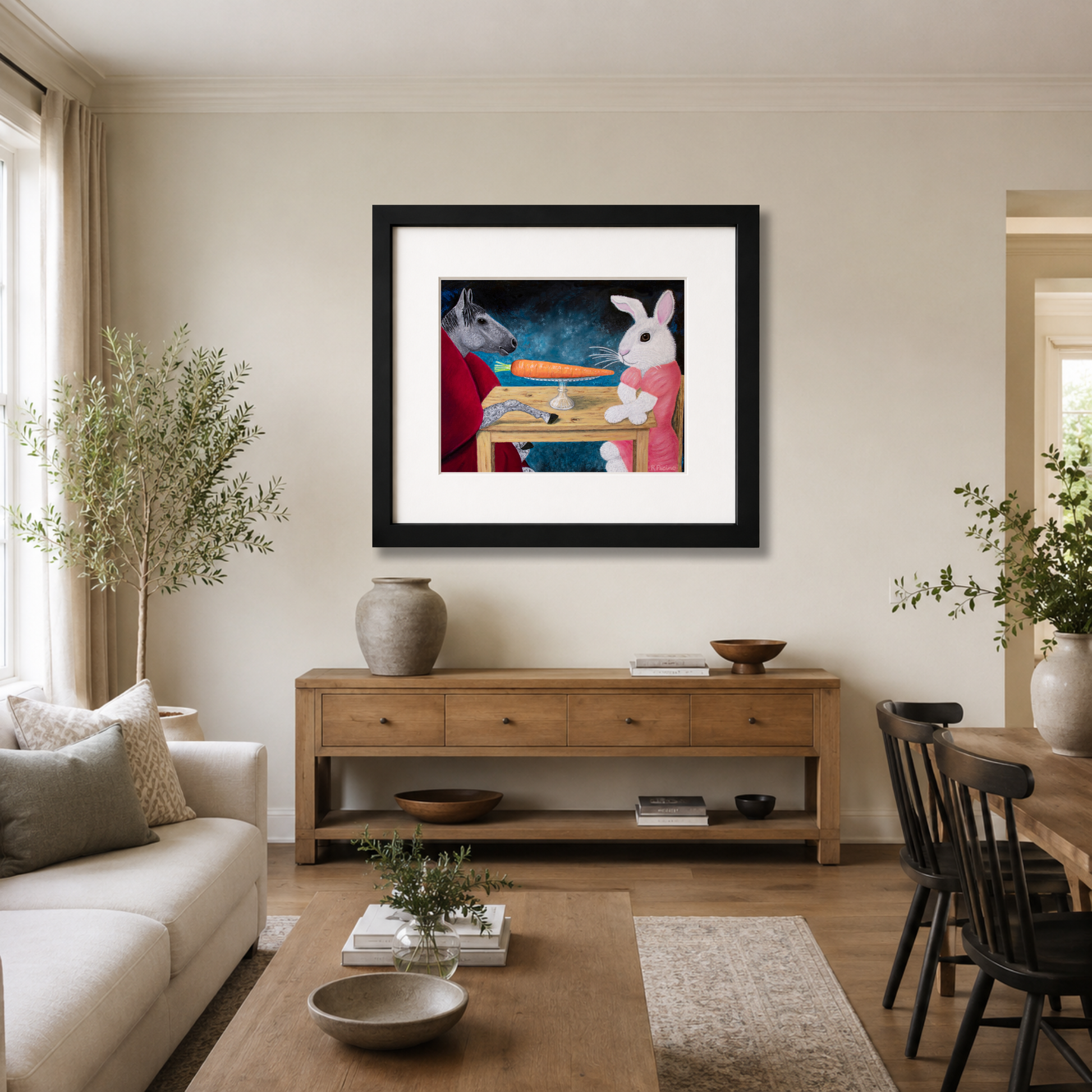 A framed art print featuring Single Carrot by Roberta Pacino, styled in a modern living room above a wooden console table