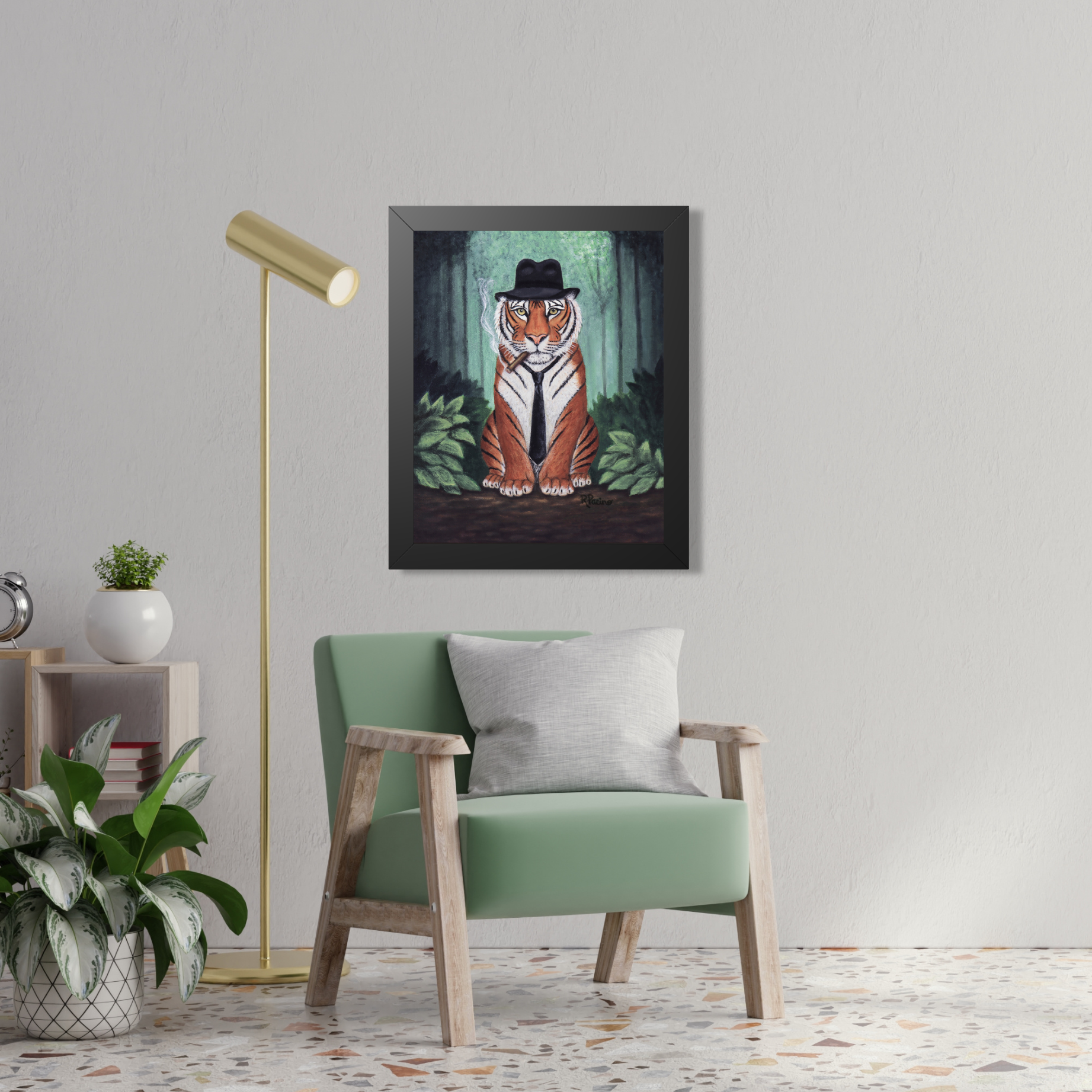 Framed artwork of a tiger wearing a fedora in a forest by Roberta Pacino, above a green armchair in a room.